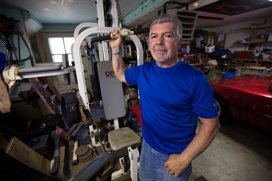 Mike Dennen, seen here in his garage in Bourne, has mesothelioma. (Jesse Costa/WBUR)