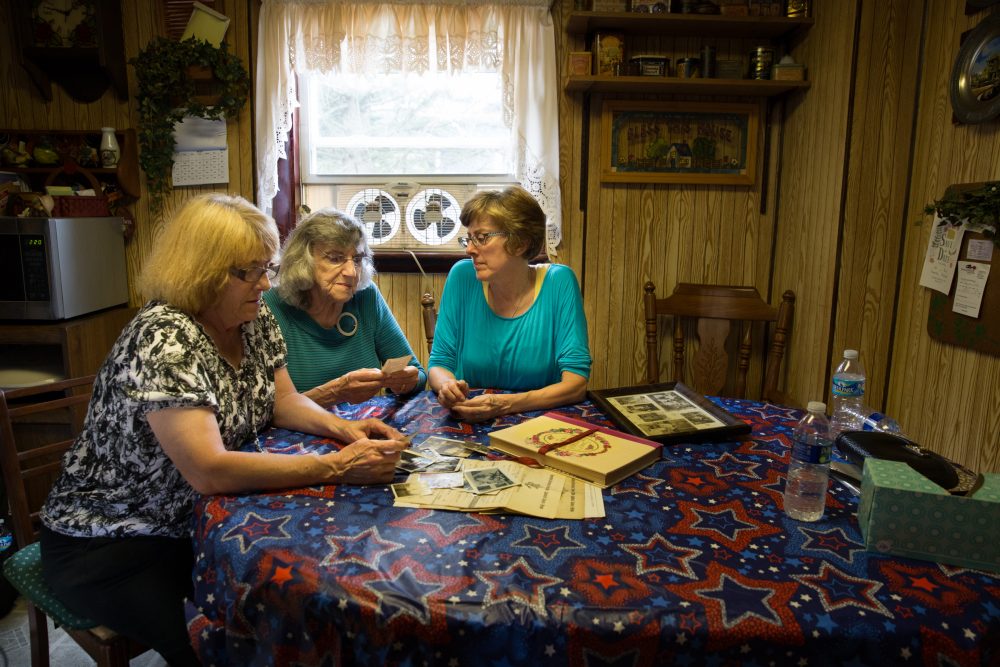 From left: Darlene Freil, granddaughter of Harold Israel; Theresa Israel, Harold's daughter-in-law; and Lisa Berrier, Harold's granddaughter, in Freil’s home in Gilberton. (Ryan Caron King for WBUR)