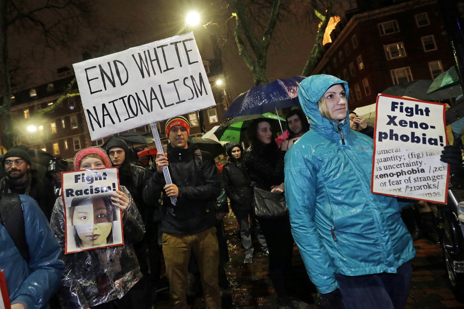 Protesters hold signs outside Harvard's John F. Kennedy School of Government, Wednesday, Nov. 30, 2016, in Cambridge, Mass. (Elise Amendola/AP