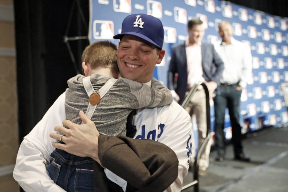 Los Angeles Dodgers pitcher Rich Hill hugs his son Brice Hill after signing a 3-year, $48 million contract on Dec. 5. (Alex Brandon/AP)