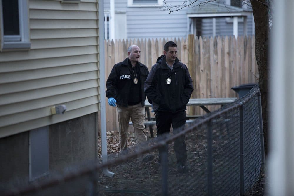 Somerville police detectives examine the area where they apprehended Morales in the backyard of 85 Wheatland St. (Jesse Costa/WBUR)