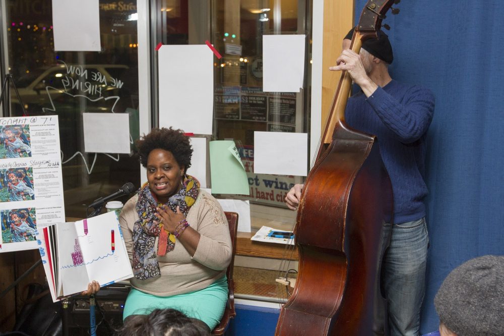 Tanya Nixon-Silberg, storyteller and co-founder of Wee The People, reads at a ResistARTS event in early January. (Joe Difazio for WBUR.)