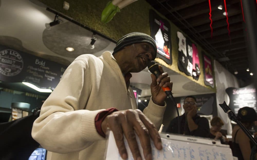 Poet Alistar Allen performing at J.P. Licks in early January as part of ResistARTS, a collaboration created to build community post-election. (Joe Difazio for WBUR.)