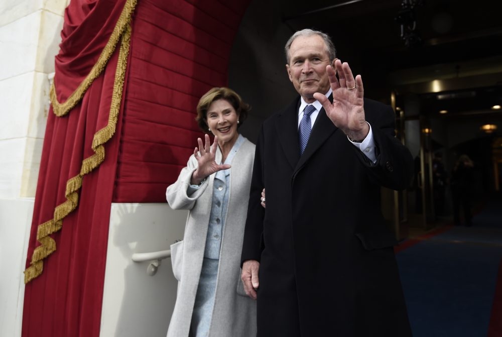 Former President George W. Bush and his wife Laura Bush wave as they arrive on Capitol Hill in Washington Friday for Trump's inauguration. (Saul Loeb/AP, Pool)