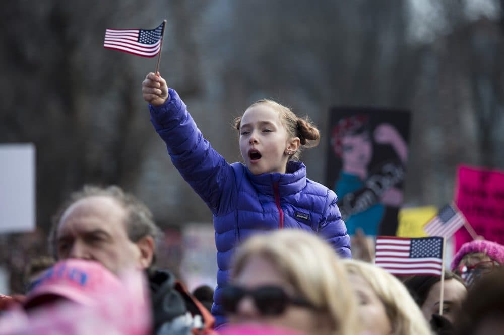 A girl on her dad's shoulders during Sen. Elizabeth Warren's speech. (Jesse Costa/WBUR)
