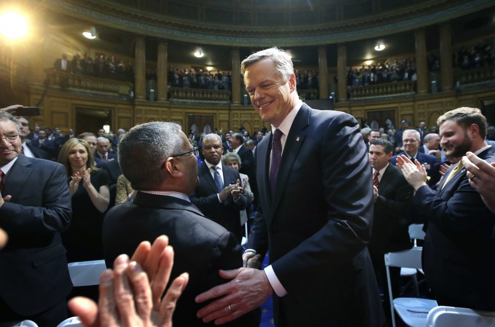 Baker greets lawmakers and guests as he enters the House chamber before his speech. (Steven Senne/AP)