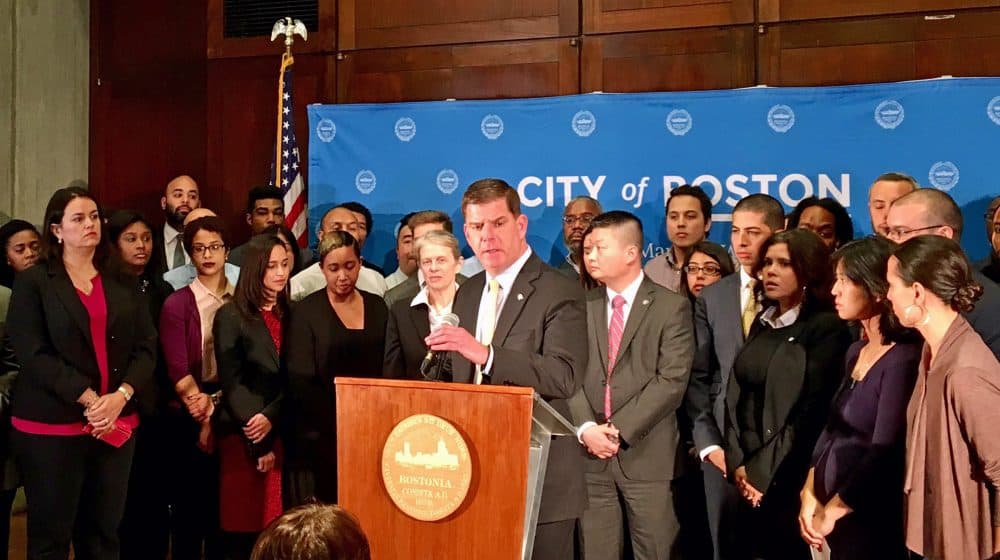 Surrounded by members of his administration and state lawmakers, Mayor Marty Walsh announced Boston will maintain its status as a "sanctuary city." (Shannon Dooling/WBUR)