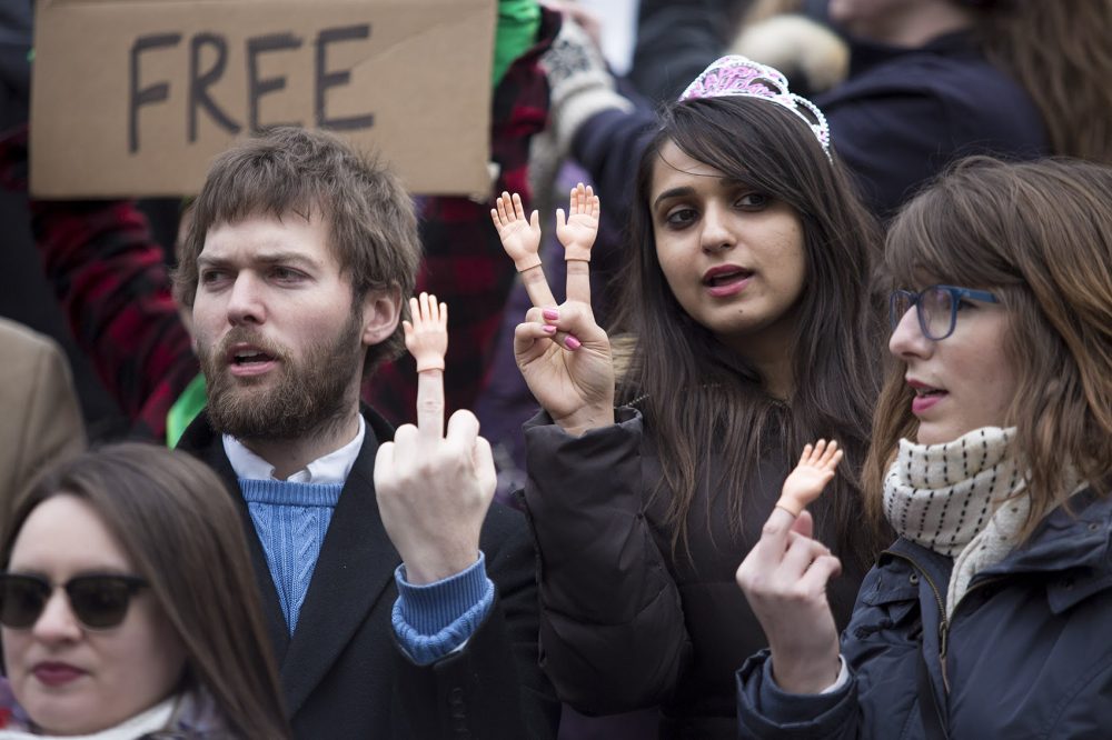 Protesters with tiny hands on their fingers. (Jesse Costa/WBUR)