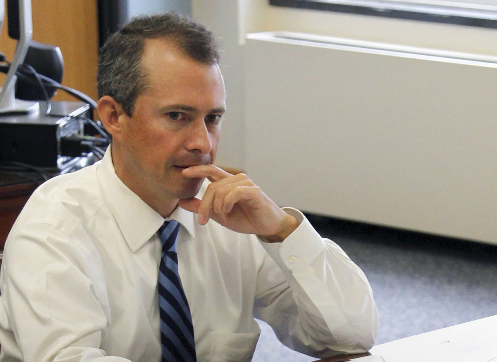 In this 2011 file photo, former Secretary of Finance for Massachusetts Jay Gonzalez meets with his budget team at the Statehouse in Boston. (Steven Senne/AP)
