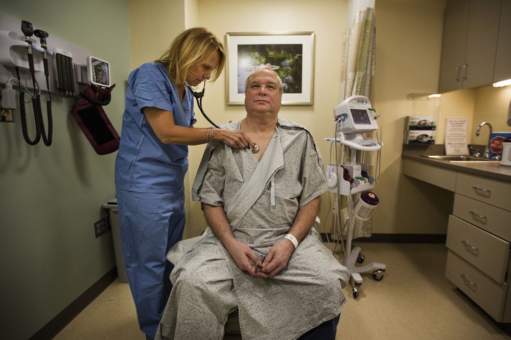 Ron Dombrowski is examined by nurse practitioner Pamela Park at the Wiener Center for Preoperative Evaluation at Brigham and Women's Faulkner Hospital. (Jesse Costa/WBUR)