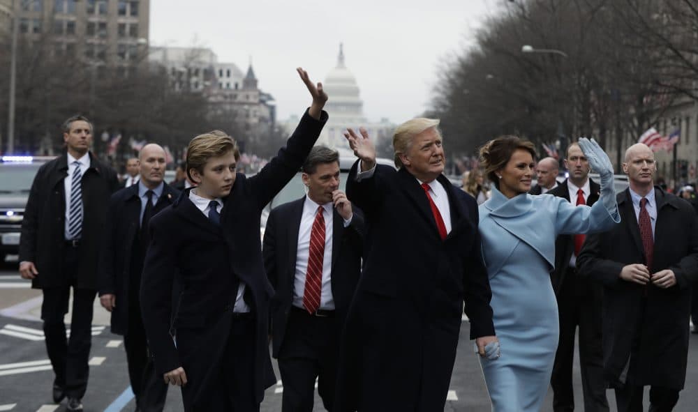 President Donald Trump waves as he walks with First Lady Melania Trump and their son Barron during the inauguration parade on Pennsylvania Avenue. (Evan Vucci/AP)