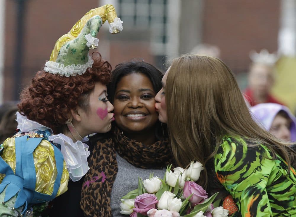 Hasty Pudding Theatricals members kiss actress Octavia Spencer during a parade to honor Spencer as Woman of the Year on Thursday in Cambridge. (Stephan Savoia/AP)