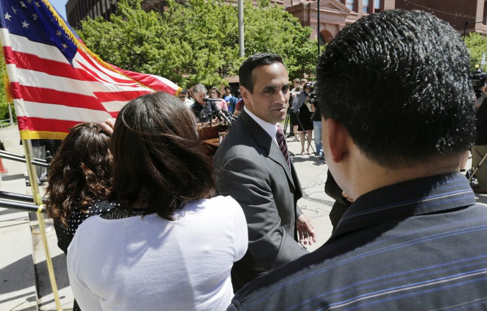 Somerville Mayor Joseph Curtatone shakes hands with residents following a 2014 news conference regarding immigration. (Charles Krupa/AP)