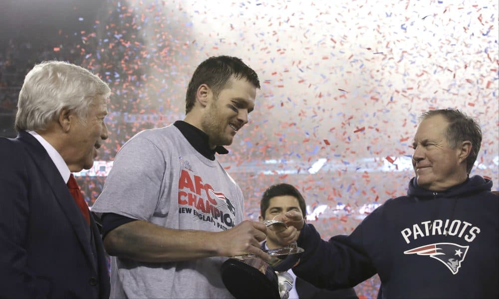 Patriots head coach Bill Belichick, right, passes the AFC Championship trophy to quarterback Tom Brady after beating the Pittsburgh Steelers, Sunday in Foxborough. At left is team owner Robert Kraft. The Patriots defeated the the Steelers 36-17 to advance to the Super Bowl. (Charles Krupa/AP)