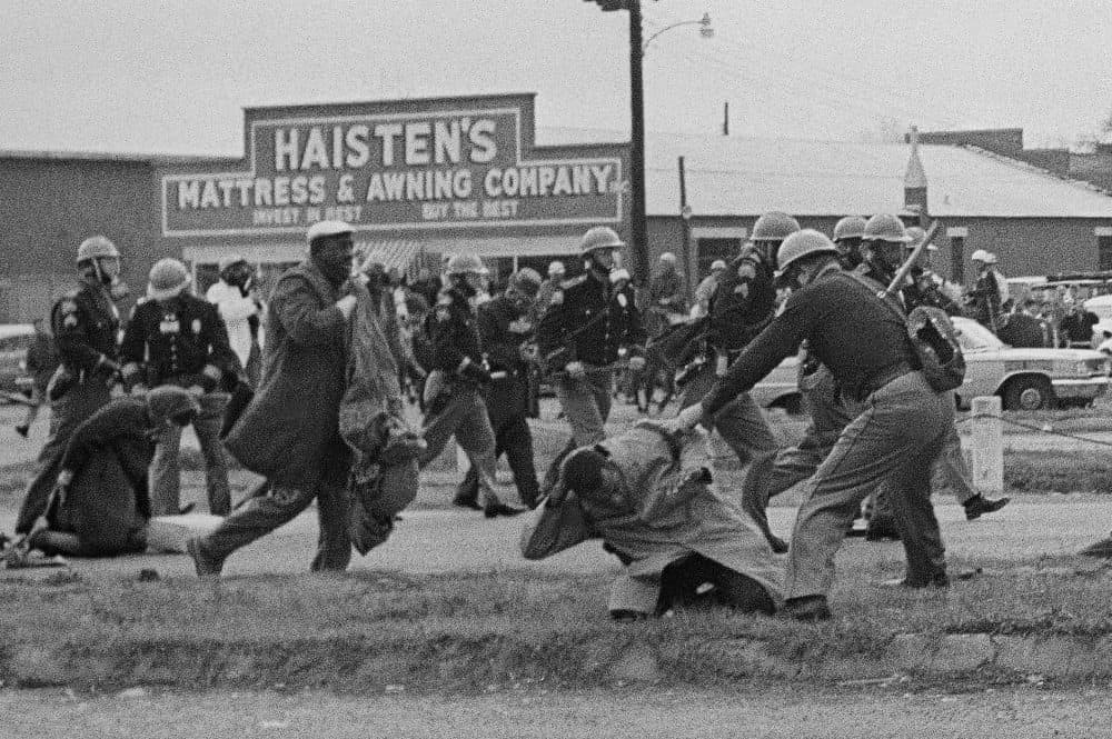 State troopers swing billy clubs to break up a civil rights voting march in Selma, Alabama, on March 7, 1965. John Lewis, who was then chairman of the Student Nonviolent Coordinating Committee, is being beaten by a trooper. (AP)