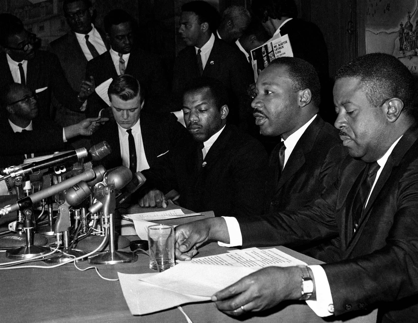 In this April 2, 1965 file photo, Dr. Martin Luther King Jr., second from right, speaks at a news conference next to John Lewis, to his left, chairman of the Student Nonviolent Coordinating Committee, in Baltimore. (William A. Smith/AP) 