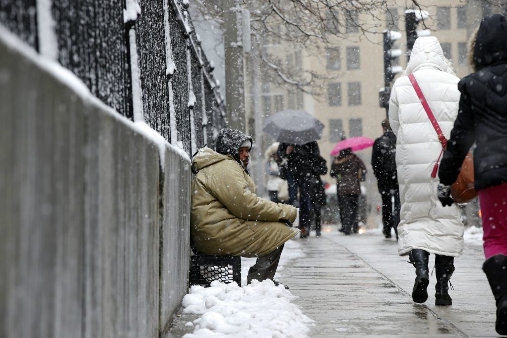 Now more than ever, writes emergency room physician Alister Martin, we must be committed to putting patients over politics. Protecting Medicaid funding is one place to start. Pictured: George "Big G" Dagracia, who is homeless, solicits from passersby under light snow in Boston, Monday, March 21, 2016. (Michael Dwyer/AP)