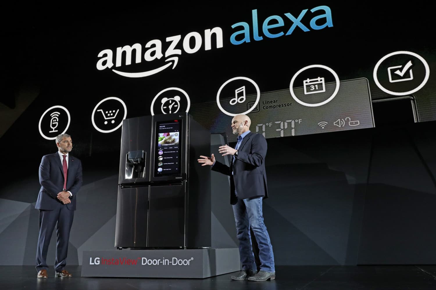LG Electronics vice president David VanderWaal and Amazon Echo vice president Mike George present the LG Smart InstaView Door-in-Door Refrigerator to CES 2017 attendees at the LG Electronics press conference. (Jack Dempsey/AP)