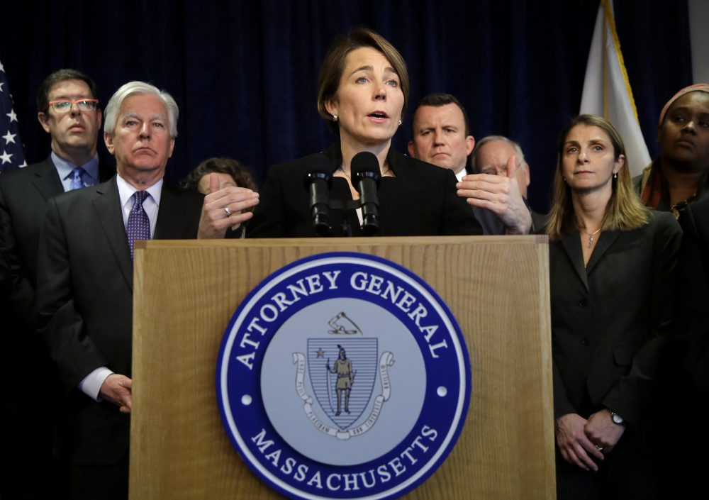 Massachusetts Attorney General Maura Healey is joining a lawsuit filed by the American Civil Liberties Union of Massachusetts challenging President Donald Trump's executive order on immigration. Martin Meehan, president of the University of Massachusetts, stands second from left. (Steven Senne/AP)