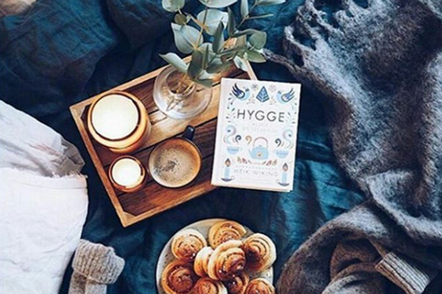 A typical &quot;hygge&quot; scene, with warm pastries, soft lighting and a copy of Meik Wiking's &quot;Little Book Of Hygge.&quot; (Valerie_bd/Instagram)