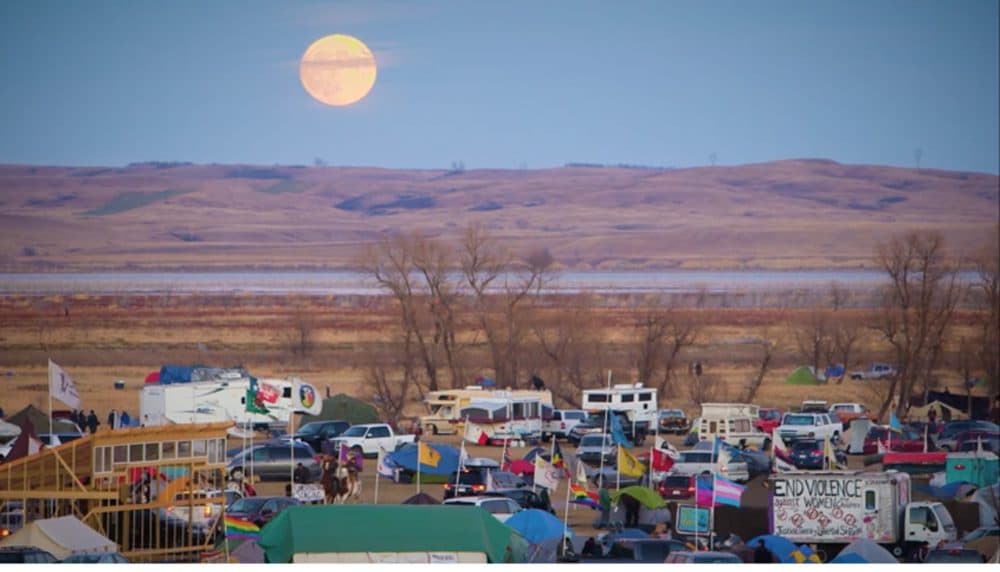 A protest camp opposing the Dakota Access Pipeline sits under a supermoon. (Brian Malone/Fast Forward Productions, LLC)