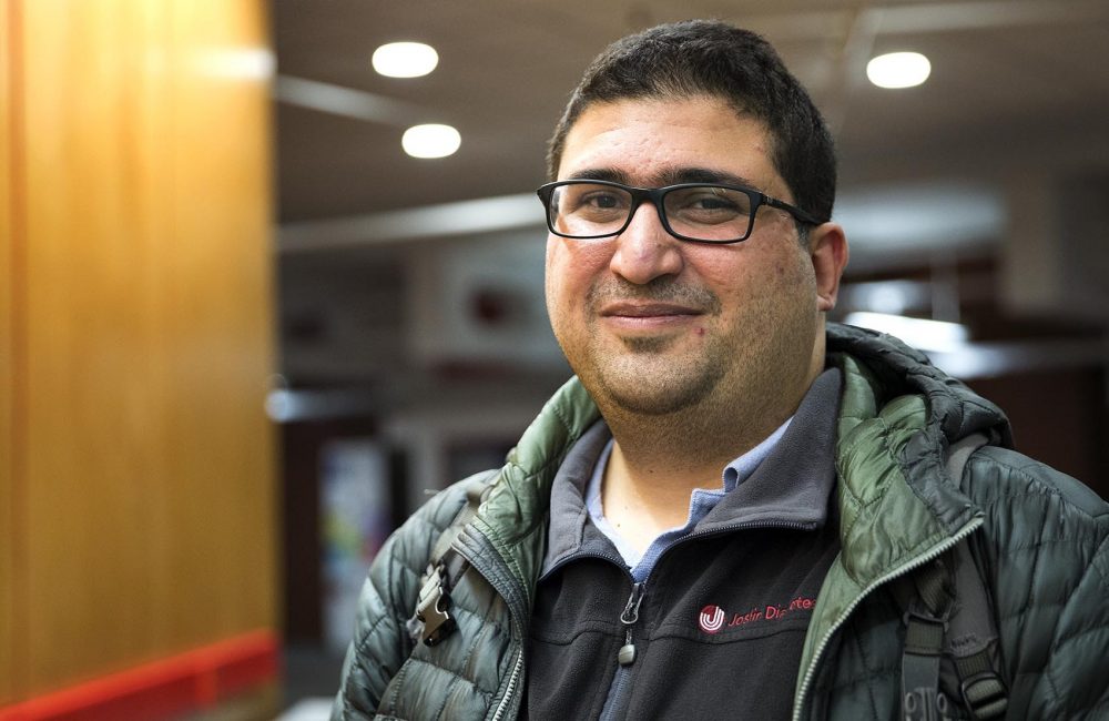 Aref Ebrahimi, 29, an Iranian, is a student at the Graduate School of Arts and Sciences at Harvard. He has a green card, but no passport. He said he can't travel outside the country without a refugee travel document, which he says he is currently unable to get. (Robin Lubbock/WBUR)