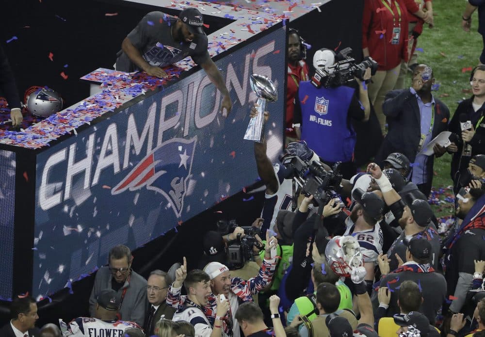 New England Patriots' James White, top left, celebrates with the Vince Lombardi Trophy. (Charlie Riedel/AP)