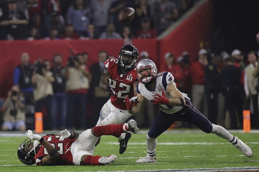 New England Patriots' Julian Edelman eyes the ball before making the catch as Atlanta Falcons' Robert Alford, left, and Keanu Neal defend, during the second half of the NFL Super Bowl 51 football game Sunday, Feb. 5, 2017, in Houston. (AP Photo/Patrick Semansky)