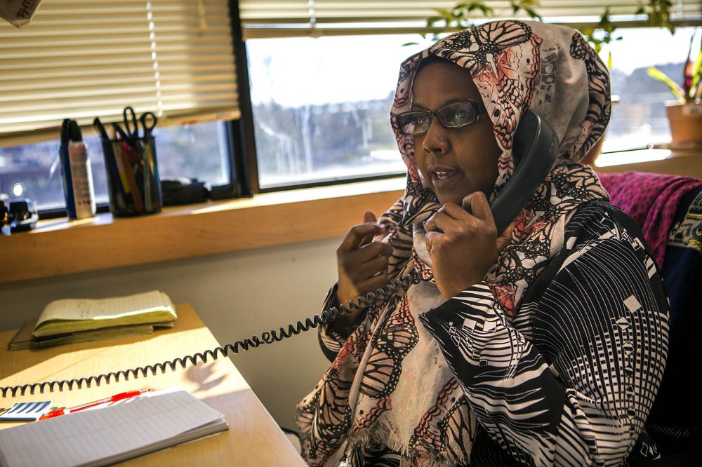 Kaftun Ahmed is a Somali interpreter and community health worker at Massachusetts General Hospital in Chelsea. Here she speaks to an immigrant patient to make sure they have received clearance for dental care. (Jesse Costa/WBUR)
