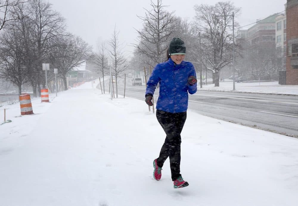 A runner braves the winter storm on Memorial Drive, Cambridge. (Robin Lubbock/WBUR)