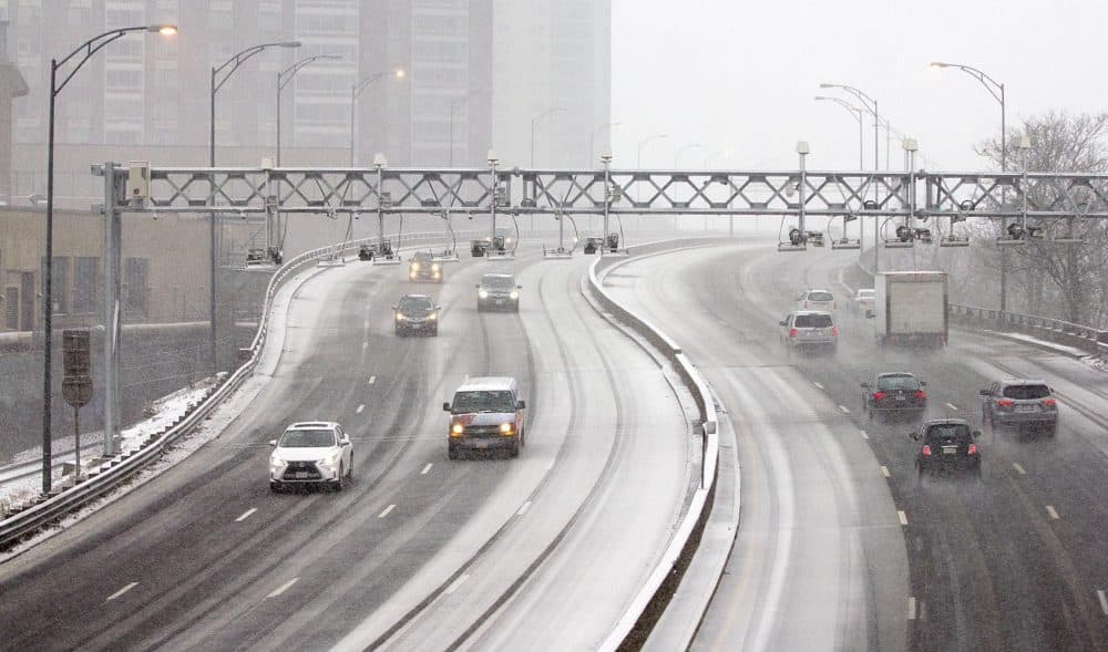 Vehicles make their way through the snow on the Mass. Pike in Boston. (Robin Lubbock/WBUR)