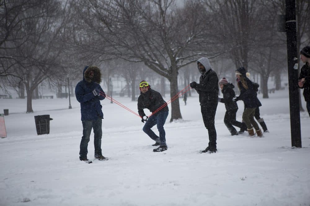 College students use a slingshot to hurl snowballs at the opposing side during a snowball fight on the Boston Common. (Jesse Costa/WBUR)