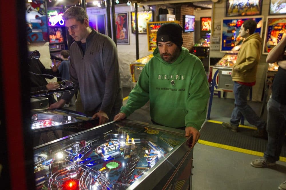 Kenny Weiner, right, plays in the Massachusetts State Pinball Championships. (Joe Difazio for WBUR)