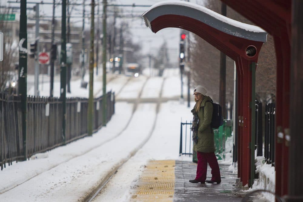 A student waits for a Green Line train on Commonwealth Ave. at the Boston University Central stop. (Jesse Costa/WBUR)