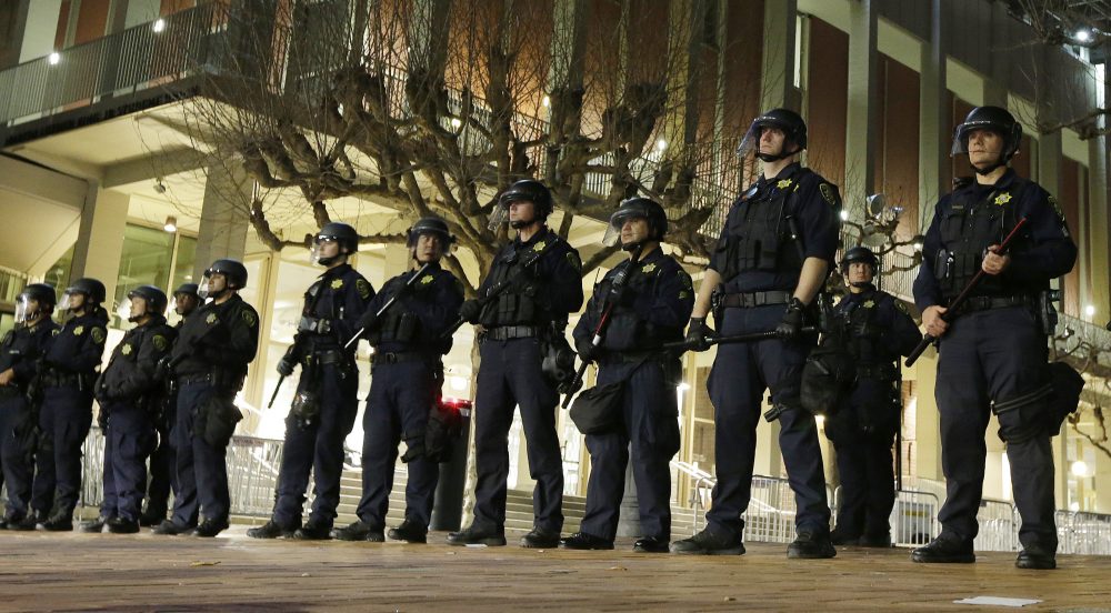 In this Feb. 1, 2017 file photo, University of California, Berkeley police guard the building where Breitbart News editor Milo Yiannopoulos was to speak. (Ben Margot, File/AP)