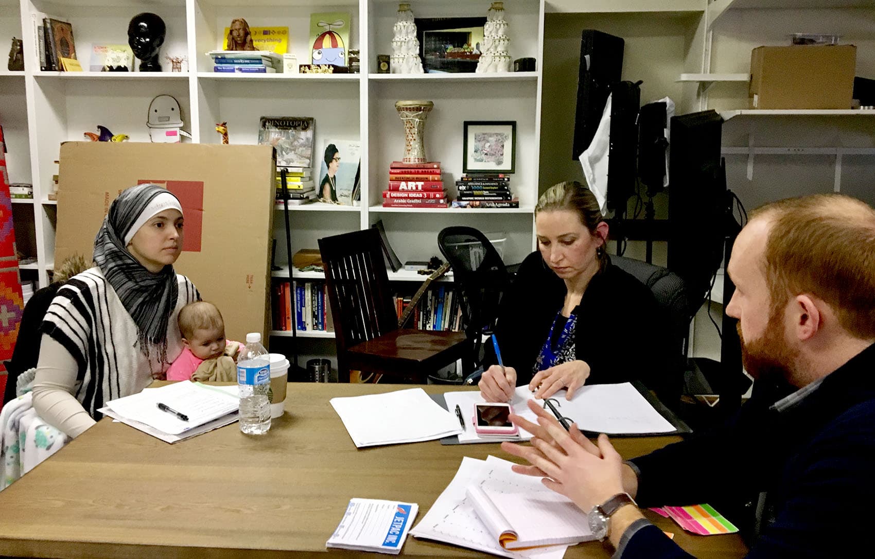 Nichole Mossalam of Malden (with her baby on her lap) and Sarah Khatib of Walpole are both exploring bids for elected office with the help of Jetpac, a nonprofit looking to engage Muslims in politics. (Shannon Dooling/WBUR)