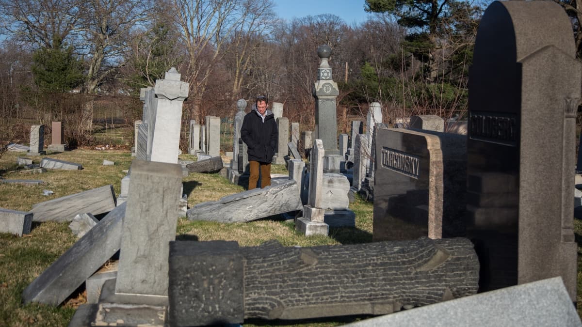 Rabbi Adam Zeff from the Germantown Jewish Centre surveys the damage at the Mt Carmel Cemetery (Emily Cohen for NewsWorks)