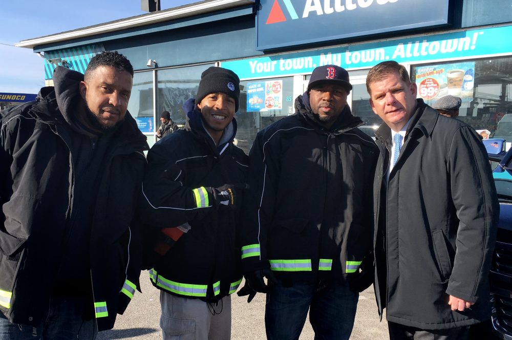 Outreach workers Paul Goncalves, Dwayne Brown and Bobbie Wright pose with Mayor Marty Walsh. (Deborah Becker/WBUR)