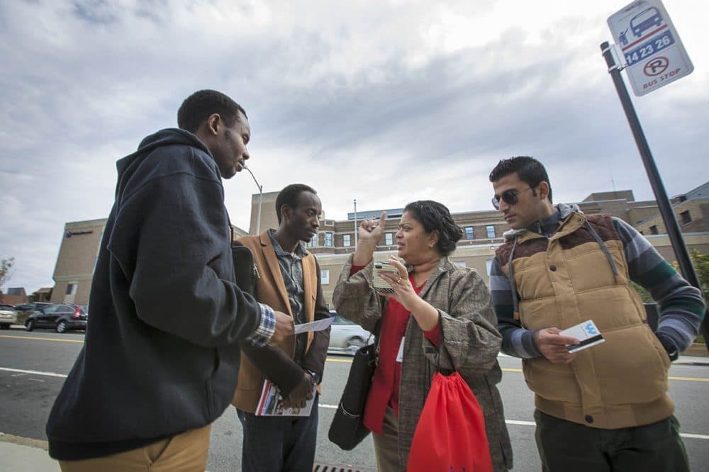 In Worcester, Ascentria Care Alliance offers a sort of one-stop shop for refugees. In this 2015 photo,, instructor Teresa Sebastian shows clients when the next WRTA bus will arrive using a phone app. (Jesse Costa/WBUR)