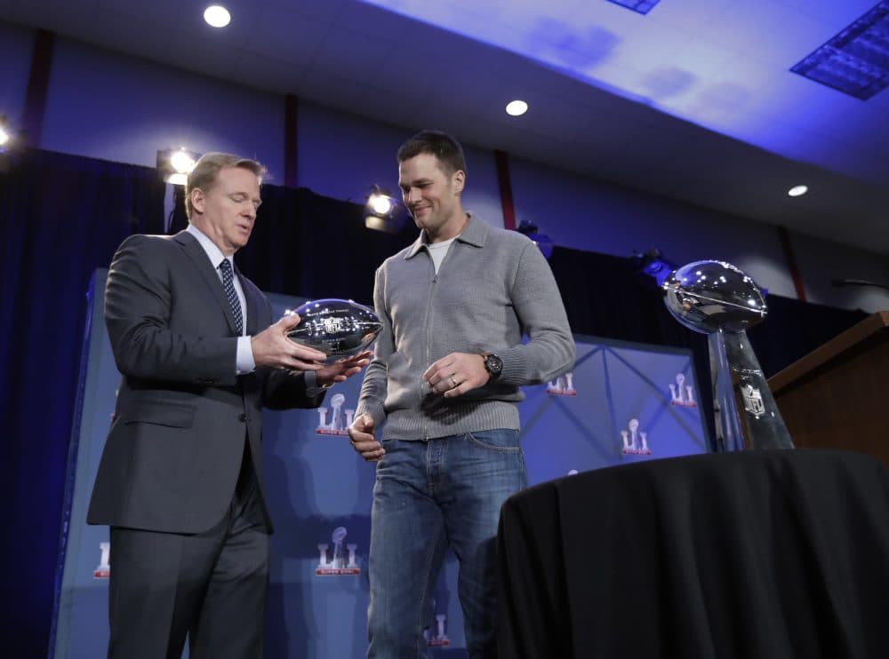NFL commissioner Roger Goodell hands Patriots quarterback Tom Brady his Super Bowl MVP trophy Monday. (David J. Phillip/AP)