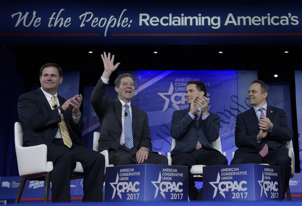 Kansas Gov. Sam Brownback, second from left, waves as he is introduced for a panel discussion at the Conservative Political Action Conference (CPAC) in Oxon Hill, Md., Thursday, Feb. 23, 2017. From left are, Arizona Gov. Doug Ducey, Wisconsin Gov. Scott Walker and Kentucky Gov. Matt Bevin. (Susan Walsh/AP)