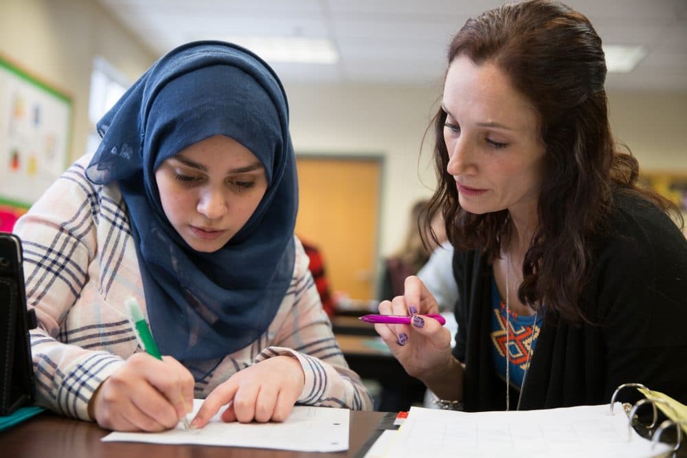 Ghena works on math schoolwork with teacher Karen Stark. (Ryan Caron King for NENC)