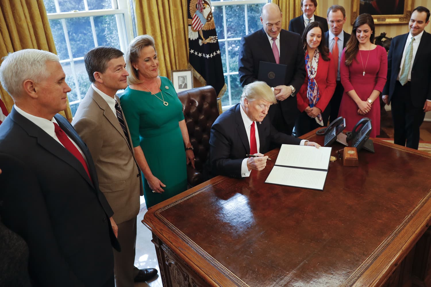President Donald Trump prepares to sign an executive order that will direct the Treasury secretary to review the 2010 Dodd-Frank financial oversight law. (Pablo Martinez Monsivais/AP)