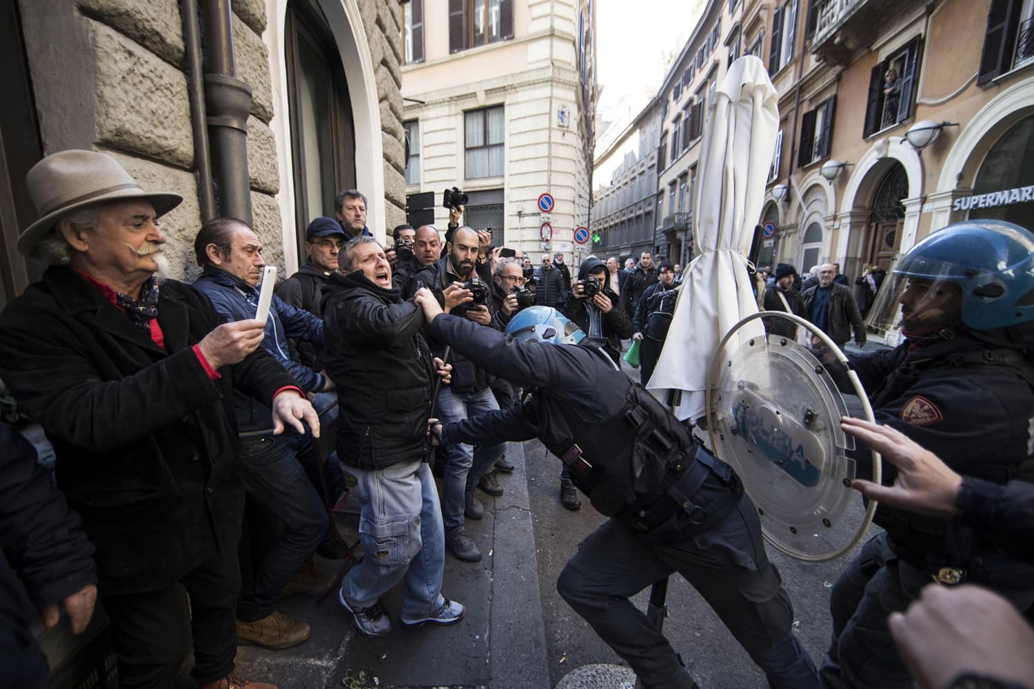 Riot police clash with taxi drivers and street sellers during a demonstration, in Rome, (Massimo Percossi/AP)