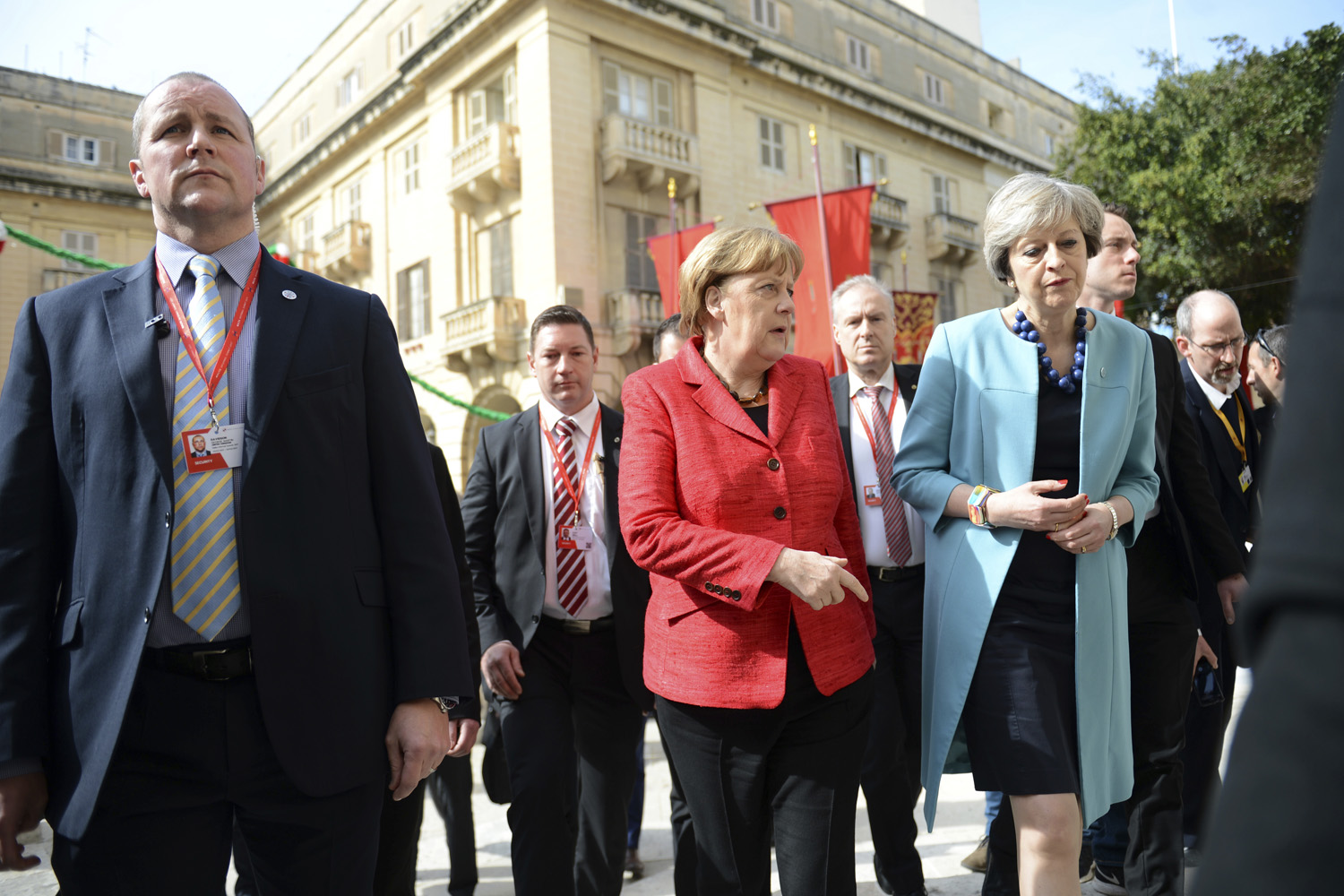German Chancellor Angela Merkel, center, speaks with British Prime Minister Theresa May, right, as they walk with other EU leaders during an event at an EU summit in Valletta, Malta.(Rene Rossignaud/AP)