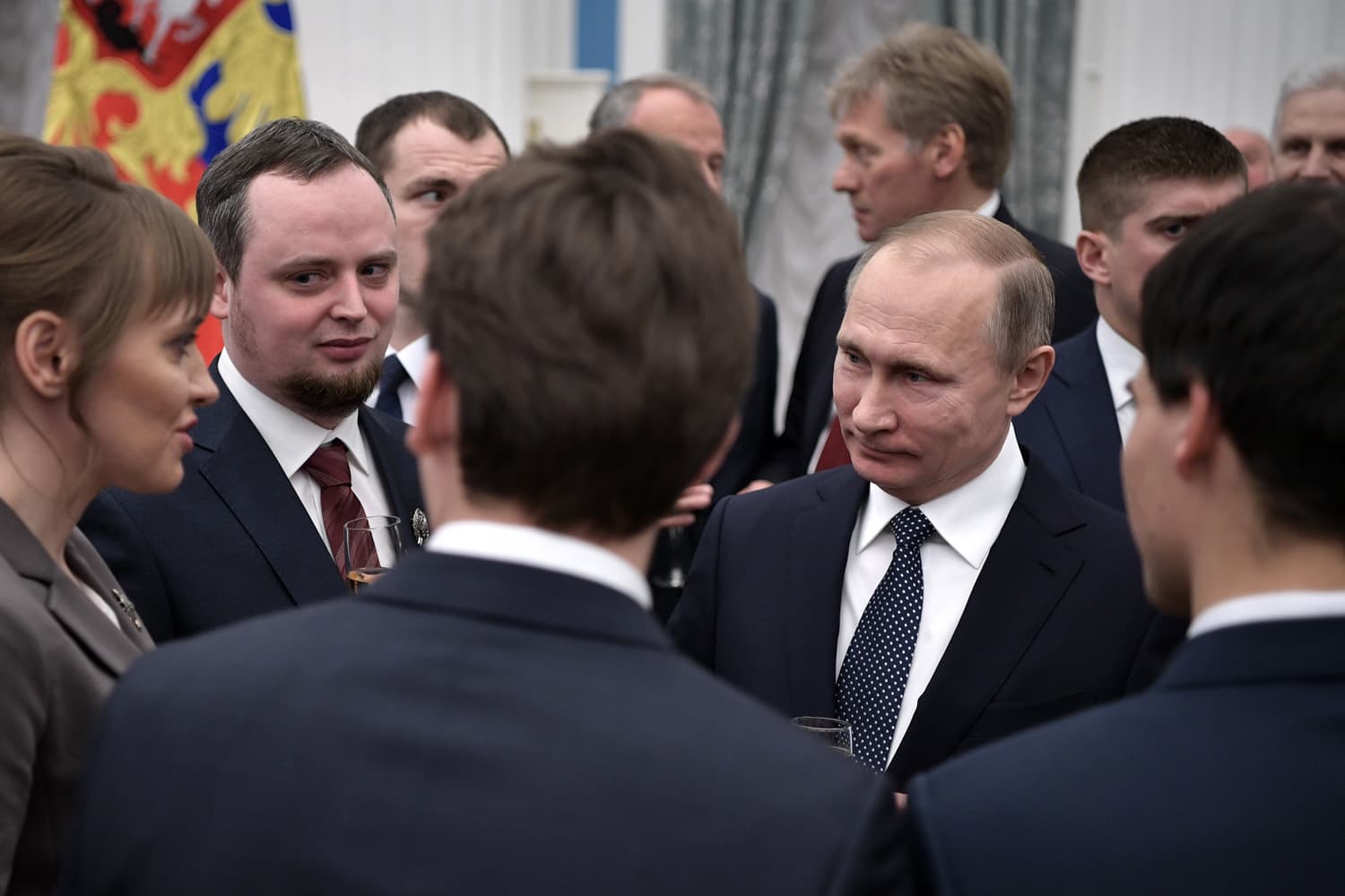 Russian President Vladimir Putin, right, speaks with winners of the 2016 Presidential prize for young scientists after an award ceremony in the Kremlin in Moscow, Russia. (Alexei Nikolsky/AP)