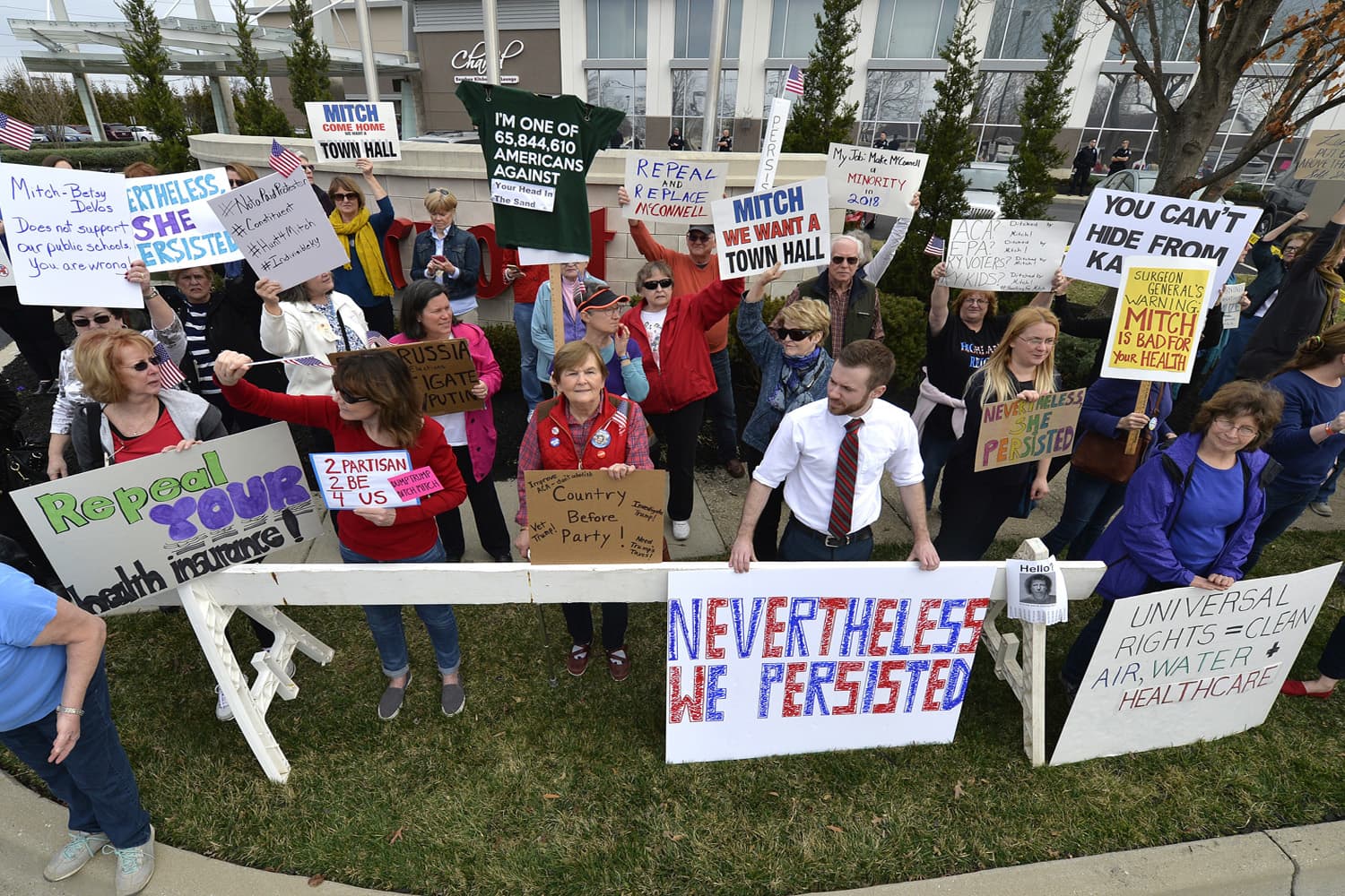 A group numbering in the hundreds gather to protest the appearance of Senate Majority Leader Mitch McConnell R-Ky., and the policies of the Trump administration outside of the Jeffersontown Chamber of Commerce luncheonn Jeffersontown, Ky. (Timothy D. Easley/AP)