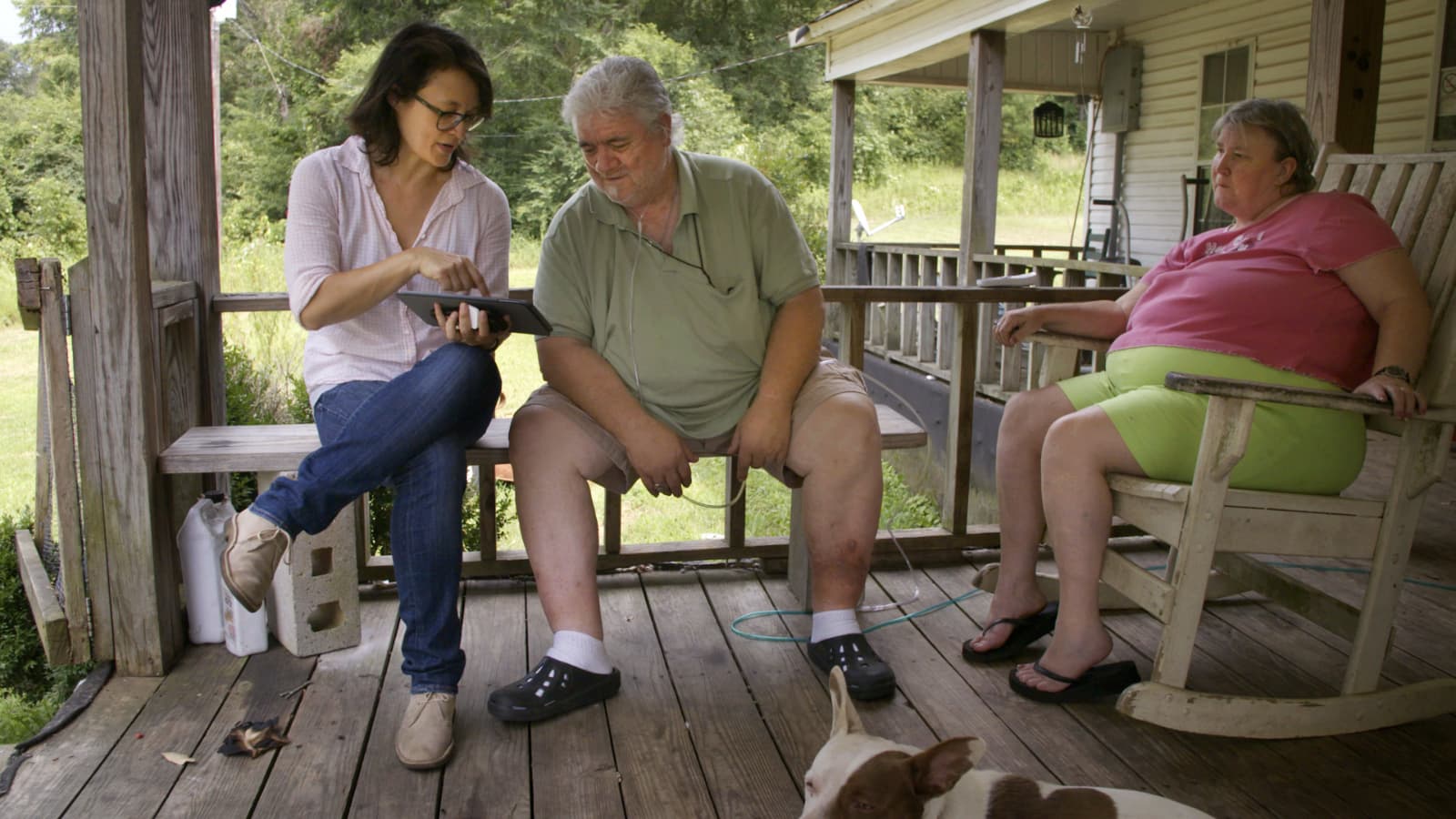 Filmmaker Jennifer Crandall (left) sits with Billy Wayne Corkerin and his wife Lucy Corkerin on the porch of their home in Fayette, Ala. The couple read verse 43 of the Walt Whitman poem &quot;Song of Myself&quot; for the project &quot;Whitman, Alabama.&quot; (Courtesy Pierre Kattar)