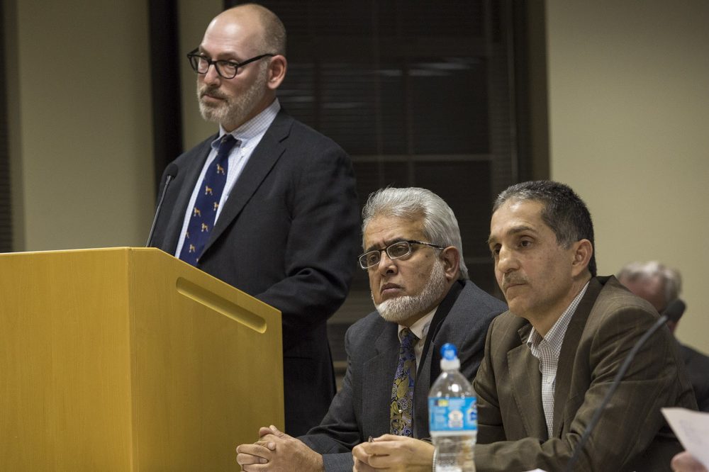 From left, Attorney Jay Talerman, Dr. Khalid Khan Sadozai and Imad Zrein, representatives of the Islamic Society, are dumbfounded after the Dudley zoning board's initial vote to reject the application for the proposed cemetery last year. (Jesse Costa/WBUR)