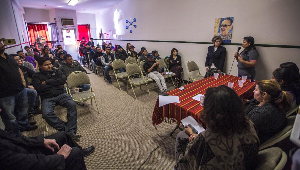 Juana Garcia tells the audience of New Bedford community members about her experiences being detained by immigration officials during the Michael Bianco factory raid. (Jesse Costa/WBUR)